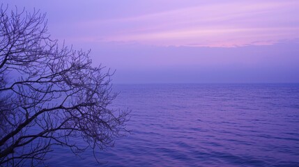 A photo of the lake at dusk, with the sky shrouded in purple and blue hues. The calm waters of the lake create a peaceful and mysterious atmosphere