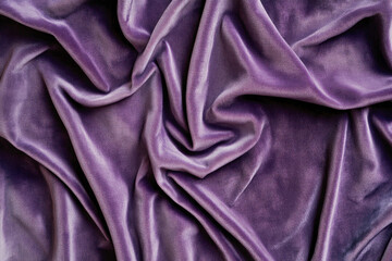 Fototapeta premium Elegant purple velvet fabric texture with soft folds and rich color