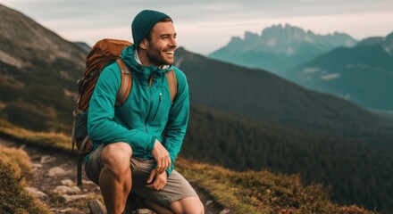 Fototapeta premium Young caucasian male hiker enjoying mountain scenery with backpack
