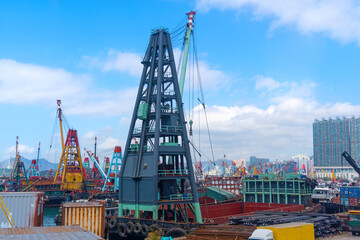 Naklejka premium Cranes ships in the bay port for import export goods and cargo