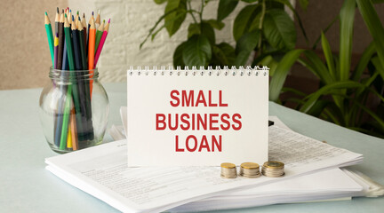 SMALL BUSINESS LOAN, handwriting text on page of office agenda. Copy space.