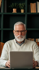 Experienced man with glasses working on lap p in cozy setting