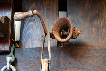 old rusty meat grinder isolated on wooden background