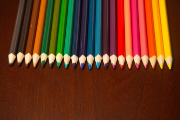 colored pencils on wood background