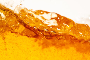 Close up bright orange Oil or beer splash texture and nature waves, Beautiful waves curve and...