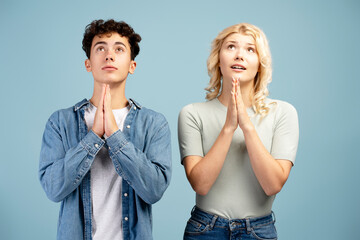 Portrait of young girl and boy, friends, prayers praying together looking up, believe