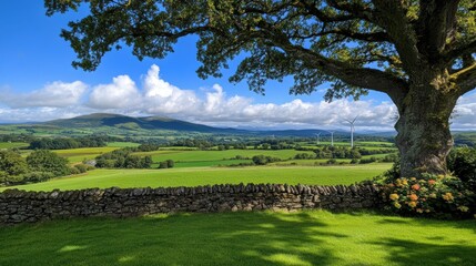 Fototapeta premium A serene landscape showcasing lush green fields, rolling hills, and wind turbines under a bright blue sky with fluffy clouds, Ideal for use in environmental, travel, or agricultural themes,