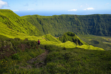 A mountaineer on a hiking trail the caldera on the Azores island Faial.