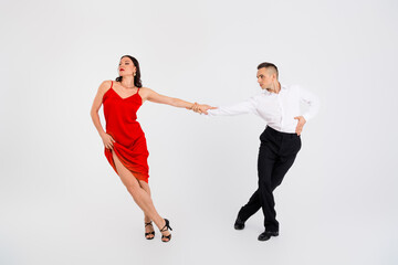 Full size photo of two young passionate dancing partners hold hands isolated on white color...
