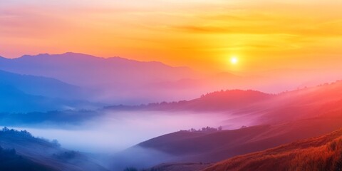 Obraz premium Vibrant sunset casts colors over the chilly, fog covered hills, creating a stunning view. This colorful sunset in the hills brings a serene beauty to the misty landscape, perfect for nature lovers.
