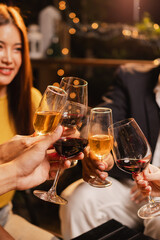 Group of friends clinking wine glasses in celebration at night, Festival celebration, Happy Asian group friends and dinner party in the night, Friendship and celebration new year concept.