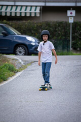cute boy skating with his skate board on a summer day
