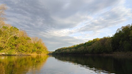Fototapeta premium Sunlight and clouds on the river