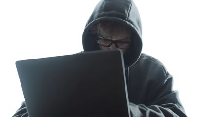 Person in hoodie working on a laptop.