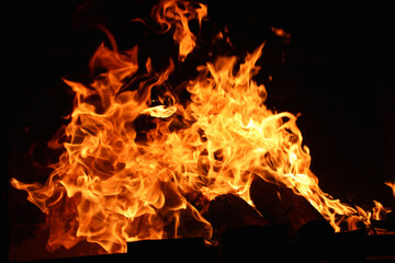 Fototapeta premium fire in the fireplace, Close-up of fire flames against a black background, Fire flames, burning wood