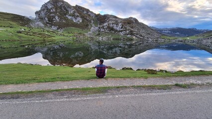 person sitting on the mountains