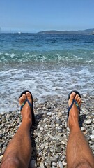 feet on the beach with stones
