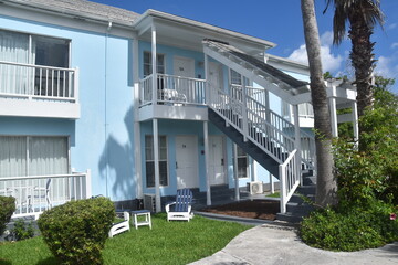 A cute colonial inspired hotel exterior design with pastel  colours by the Caribbean sea in Bahamas