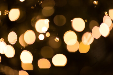 Fototapeta premium Christmas decorations light bokeh balls on dark background.