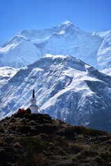 Buddhist stupas, monuments and prayer flags in the tall himalayan mountains of Nepal.