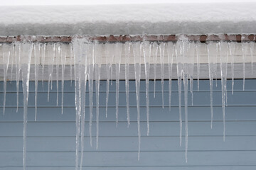 Beautiful icicles cascading from a roof and providing a view