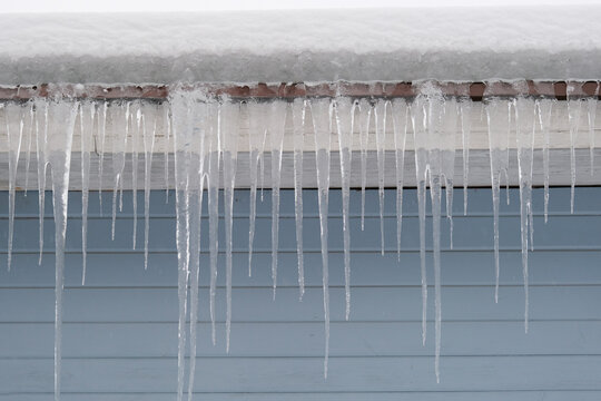Beautiful icicles cascading from a roof and providing a view