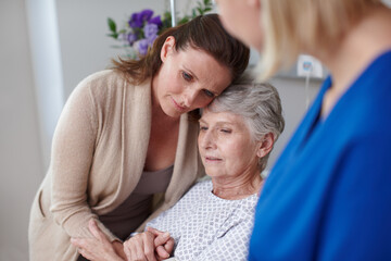 Daughter, senior person and nurse in clinic for visit, diagnosis or comfort as cancer patient....