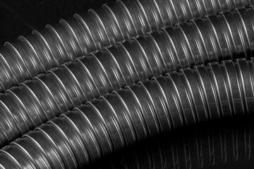Black and white macro image of a shower hose