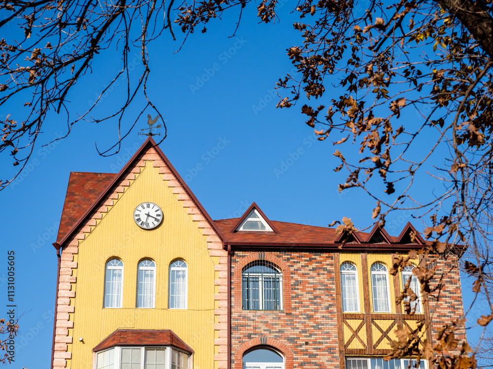 Sticker facade of urban house with wall clock in autumn