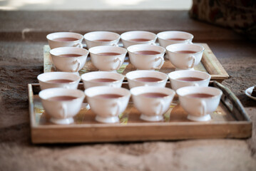 Tea cups resting on wooden trays in sri lanka