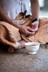 Woman meditating with herbal tea in sri lanka enjoying peaceful moment