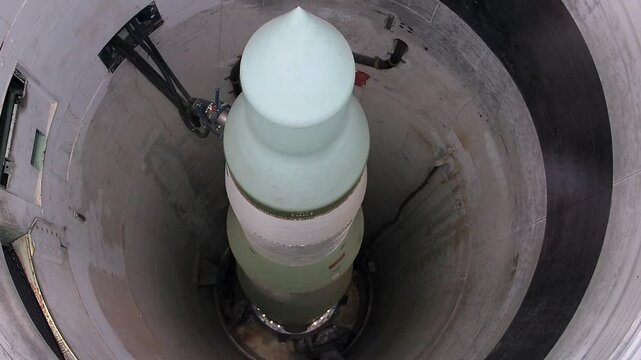 Vertical panning shot of minuteman nuclear missile in underground silo