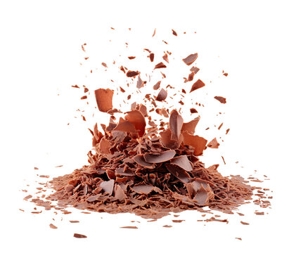 Close up of milk chocolate shavings scattered and falling, showing a dynamic explosion of fragments. Isolated cutout on transparent or white background.