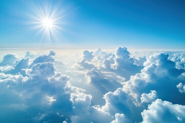 Fototapeta premium Bright sun shining over fluffy clouds in a vibrant blue sky