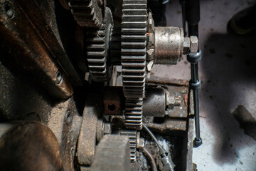 A close-up of industrial metal gears showcases precision engineering and mechanical design. The...