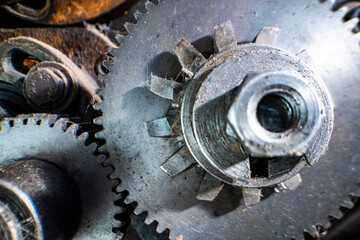 A close-up of industrial metal gears showcases precision engineering and mechanical design. The...