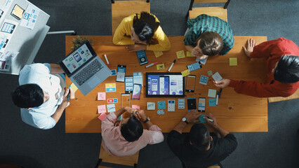 Top view of developer team working together to write idea about Ux Ui design on whiteboard. Smart...