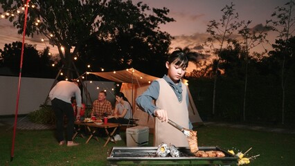 Family gather celebrate holiday, Adorable child grill food for family member. Outdoor camping...