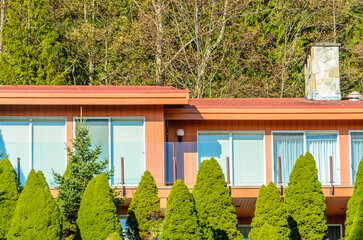 Top of grey luxury house with shingle roof, red and yellow trees and nice windows in Summer in...