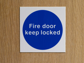 Sign with fire door keep locked on door