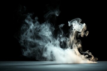 Fototapeta premium Smoke swirling in artistic patterns against a dark background showcasing fluid motion and texture