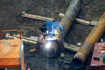 Men Welding Pipe