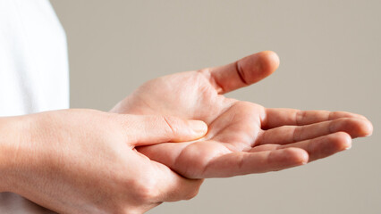 Health care and medical concept, rheumatism woman hand pain from cramp, trigger finger, wrist pain...