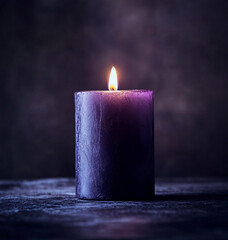 Burning purple candle on dark purple background 
