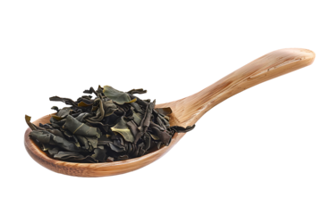 Dried leaves of oolong tea, Camellia sinensis, dark green tea, isolated on transparent background, in wooden spoon