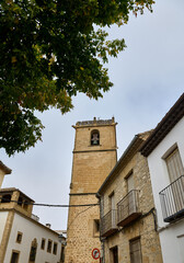 Historic stone tower surrounded by charming architecture and lush greenery
