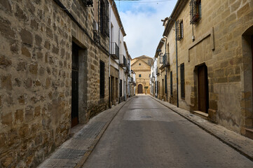 Fototapeta premium Quiet, narrow European street lined with old stone buildings