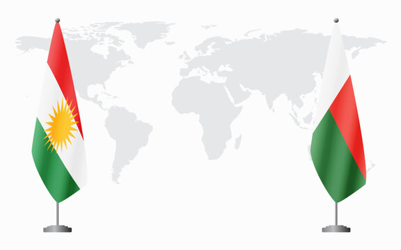 Kurdistan and Madagascar flags for official meeting against background of world map.