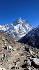 A mountain range with a snow covered peak and a blue sky
