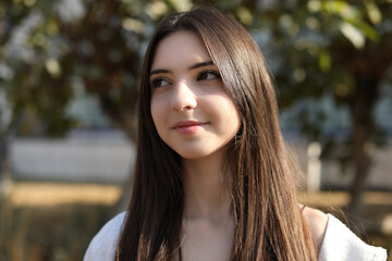 Portrait of beautiful teenage girl on city street